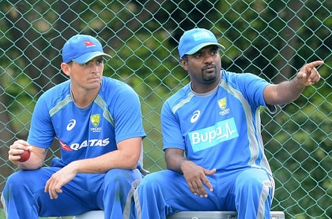 Australia's bowling consultant, Sri Lankan former cricketer Muttiah Muralitharan (R) speaks with Australian cricketer Stephen O'Keefe (L) during a practice session at the Pallekele International Cricket Stadium in Pallekele on July 23, 2016. | AFP