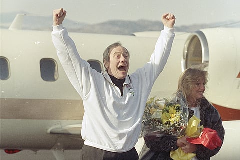 Thomas Sutherland jumps and shouts after arriving at Fort Collins-Loveland Airport outside his hometown of Fort Collins, Colo. Sutherland spent six and one-half years as a hostage in Lebanon before being released Nov. 18. Sutherland's daughter Kit is at 