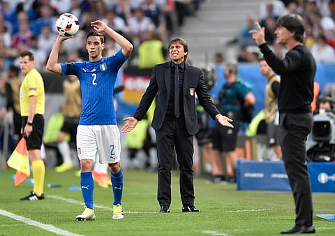 Italy coach Antonio Conte, center, and Germany coach Joachim Loew, right, gestures as Italy's Mattia De Sciglio throws the ball during the Euro 2016 quarterfinal soccer match between Germany and Italy, at the Nouveau Stade in Bordeaux, France. |AP