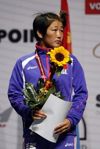 Silver medalist Mongolia's Sumiya Erdenechimeg celebrates on the podium of the women's free style 51 kg category of the World Wrestling Championships in Budapest on September 18, 2013. | AFP