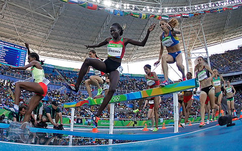 Kenya's Hyvin Kiyeng Jepkemoi, center, and Romania's Ancuta Bobocel, right, compete in the women's 3000-meter steeplechase during the athletics competitions of the Summer Olympics in Rio de Janeiro, Brazil, Saturday, Aug. 13, 2016. | AP