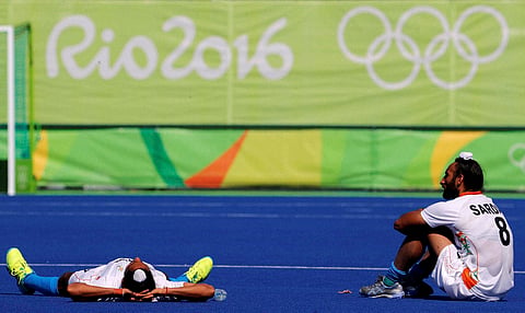 Players from India stay in the pitch a little longer after they lost to Belgium during a men's field hockey quarter final match at the 2016 Summer Olympics in Rio de Janeiro Brazil Sunday Aug. 14 2016. | AP