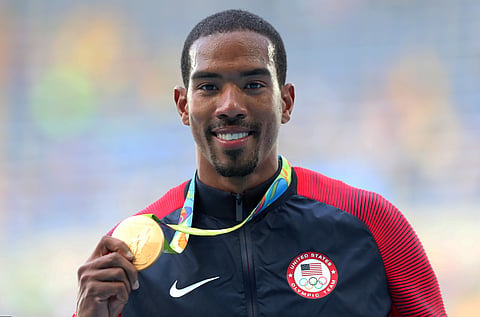 United States' Christian Taylor shows off his gold medal during the medal ceremony for the men's triple jump during the athletics competitions of the 2016 Summer Olympics at the Olympic stadium in Rio de Janeiro, Brazil, Tuesday, Aug. 16, 2016. | AP