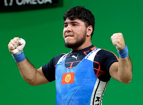 Izzat Artykov, of Kyrgystan, celebrates after a lift in the men's 69kg weightlifting competition at the 2016 Summer Olympics in Rio de Janeiro, Brazil, Tuesday, Aug. 9, 2016. | AP