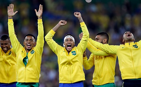 Brazil's Neymar, center, celebrates with teammates during the medal ceremony after the final match of the men's Olympic football tournament between Brazil and Germany at the Maracana stadium in Rio de Janeiro, Brazil, Saturday, Aug. 20, 2016. | AP