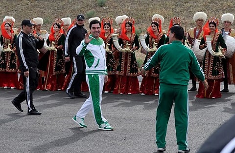 Turkmen President Gurbanguly Berdymukhamedov (C) waves to the media during the starting ceremony of a 500-day nationwide horse race at the historical site of Nisa just outside Ashgabat on May 5, 2016 in preparation for the 2017 Asian Indoor and Martial Ar