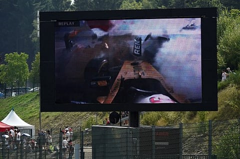 A giant display shows the crash of Renault Sport F1 Team's Danish driver Kevin Magnussen during the Belgian Formula One Grand Prix at the Spa-Francorchamps circuit in Spa on August 28, 2016. | AFP