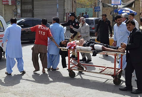People carry an injured lawyer to a hospital following a bomb blast in Quetta, Pakistan. (AP)