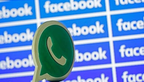 A 3D printed Whatsapp logo is seen in front of a displayed Facebook logo in this illustration taken April 28, 2016. REUTERS