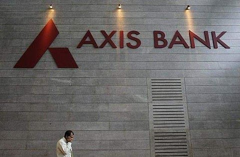 An employee speaks on his mobile phone as he walks inside Axis Bank's corporate headquarters in Mumbai July 17, 2012. REUTERS