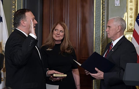 Vice President Mike Pence, right, swears in CIA Director Mike Pompeo, left, as Pompeo's wife Susan, center, watches in the Vice President's Ceremonial Office in the Eisenhower Executive Office Building in the White House complex in Washington, Monday, Jan