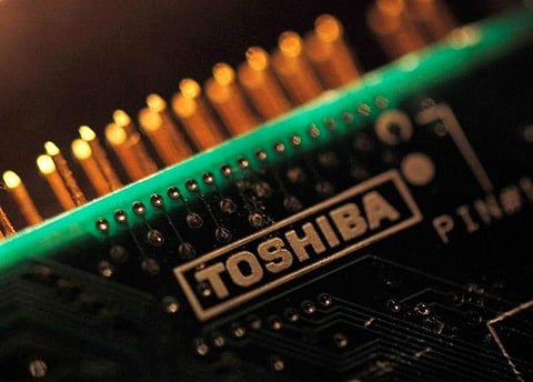 A logo of Toshiba Corp is seen on a printed circuit board in this photo illustration taken in Tokyo July 31, 2012. REUTERS