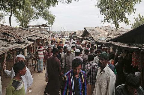 Rohingya from Myanmar make their way in an alley at an unregistered refugee camp in Teknaf, near Cox's Bazar. 