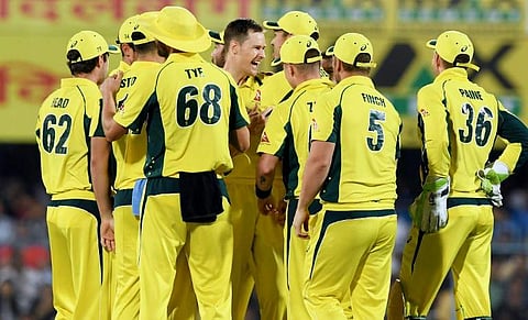 Australia's Jason Behrendorff (C) celebrates with teammates after taking the wicket of India's captain Virat Kohli during the second T20 match of the India-Australia cricket series at the Assam Cricket Association stadium in Guwahati on October 10, 2017.|