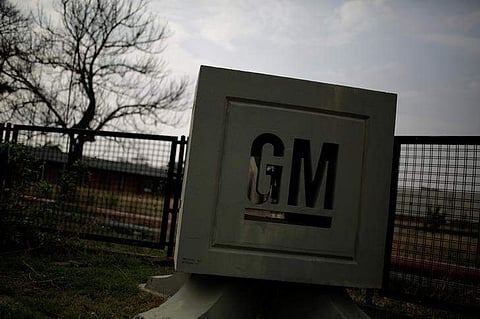 The GM logo is seen at the General Motors Assembly Plant in Valencia. (Photo | Reuters)