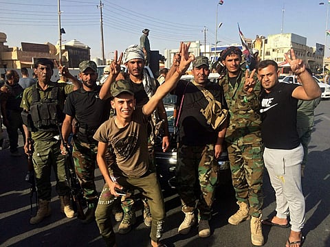 Iraqi security forces and volunteers celebrate in front of Governorate Council Building in Kirkuk, 290 kilometers (180 miles) north of Baghdad, Iraq, Monday, Oct. 16, 2017. | AP