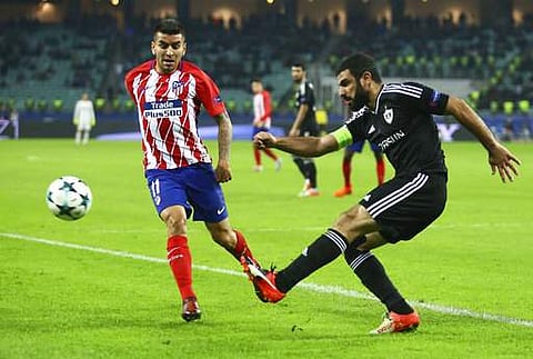 Atletico Madrid's Angel Correa, left, with Qarabag's Rashad Sadygov during the Champions League, group C, soccer match. | AP