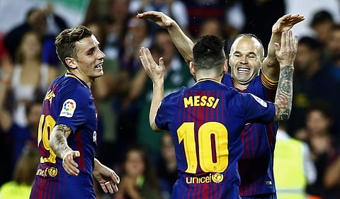 FC Barcelona's Andres Iniesta, right, celebrates after scoring during the Spanish La Liga match against Malaga. | AP