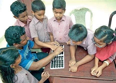 Vinod B explains the calculations using Equation board for visually challenged, to his students at Government School for Visually Impaired at Vazhuthacaud    Manu R Mavelil