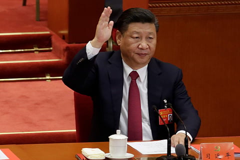 Chinese President Xi Jinping raises his hand as he takes a vote at the closing session of the 19th National Congress of the Communist Party of China. (Photo | Reuters)