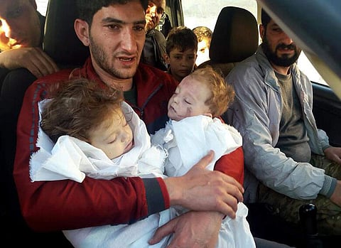 Abdel Hameed Alyousef holds his twin babies who were killed during the chemical weapons attack . (Photo | AP)