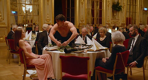 This image released by Magnolia Pictures shows Terry Notary, center, in a scene from 'The Square.' (Magnolia Pictures via AP)
