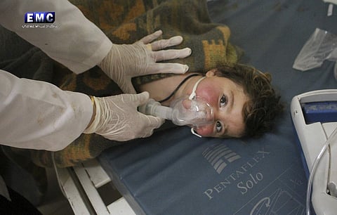 A doctor treating a child following a suspected chemical attack, at a makeshift hospital, in the town of Khan Sheikhoun, northern Idlib province, Syria. (File photo | AP)