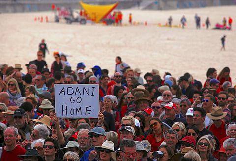 Protestors participating in a national Day of Action against the Indian mining company Adani's planned coal mine project at Sydney's Bondi Beach in Australia. (Photo | Reuters)