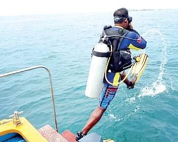 Aeron Fernandes, a diving instructor, gives a demo to mediapersons off the shore of Kaup beach on Sunday