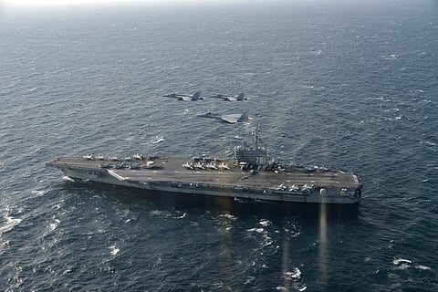 In this Nov. 10, 2017 photo provided by Japan Air Self-Defense Force, two of U.S. F/A-18, and Japan Air Self-Defense Force's F-15 fly over the USS Ronald Reagan head to a joint military exercise at an undisclosed location. (Associated Press)