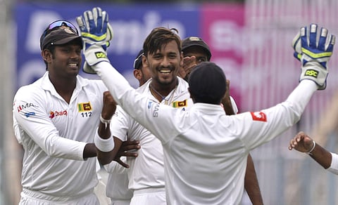 Sri Lanka's Suranga Lakmal, center without cap, celebrates with teammates the dismissal of India's Lokesh Rahul during the first day of their first test cricket match in Kolkata. | AP