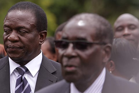 In this file photo Emmerson Mnangagwa is seen in the background while Robert Mugabe is seen in the foreground. (Photo | Associated Press)