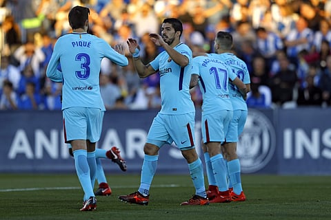 Barcelona's Luis Suarez, right, celebrates with teammate Gerard Pique after scoring his side's second goal against Leganes. | AP