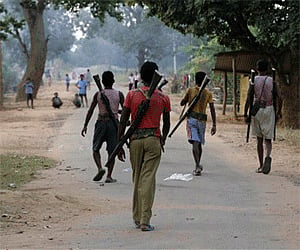 Special police officers walking at a Salwa Judum, or purification hunt camp in Dantewada. AP