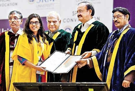 Vice-President M Venkaiah Naidu handing over certificate to a student at a special convocation of SRM University in Chennai on Thursday. Governor Banwarilal Purohit is also seen | Express