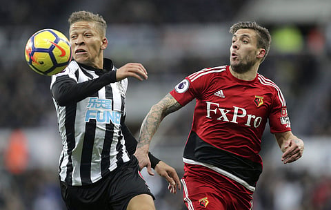 Newcastle United's Dwight Gayle, left, and Watford's Kiko Femenia battle for the ball during their English Premier League soccer match at St James' Park in Newcastle, England, Saturday Nov. 25, 2017. | AP