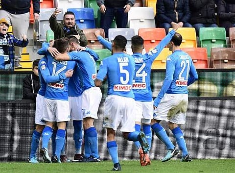 Napoli's Brazilian midfielder Jorginho (L) celebrates with teammates after scoring during the Italian Serie A football match Udinese vs Napoli at the Dacia Arena in Udine on November 26, 2017. | AFP