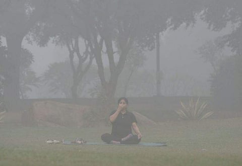 A woman practices yoga in New Delhi amid smog conditions. The air pollution levels have reached critical levels in the national capital on Tuesday. 