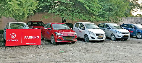 Four-wheelers belonging to a company, which offers vehicles on rent for self-drive, are being parked at the S V Road station for past one month, leaving litte space for Metro commuters to park their vehicles |express