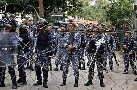 Riot policemen stand guard in front of the US embassy during a demonstration in Aukar, east of Beirut, Lebanon. | AP