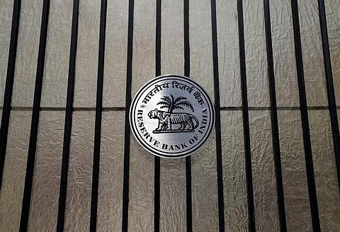 A Reserve Bank of India (RBI) logo is seen at the entrance gate of its headquarters in Mumbai. | REUTERS