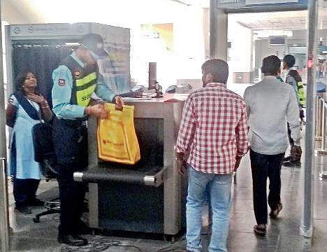 A security personnel checks the bags of commuters manually after the baggage scanner stopped functioning, at Ameerpet Metro station on Saturday | Express