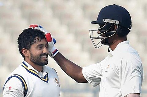 Karnataka's Abhimanyu Mithun congratulates Karun Nair for his century in the Ranji Trophy semi-final match against Vidarbha in Kolkata. (PTI)