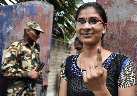 A girl shows her finger marked with the indelible ink after casting her vote for the Dr Radhakrishnan Nagar Assembly constituency bypoll in Chennai on Thursday. (Photo | PTI)