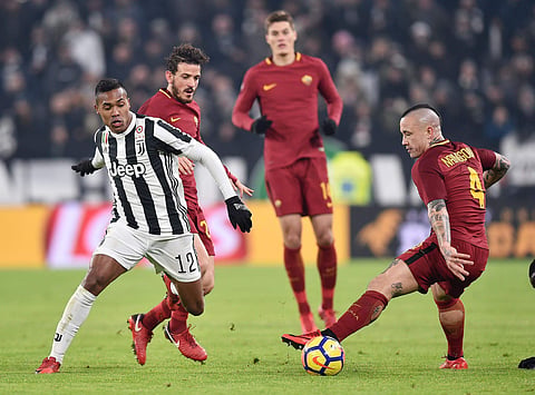 Juventus' Alex Sandro, left, and Roma's Radja Nainggolan vie for the ball during the Italian Serie A soccer match in Turin. | AP