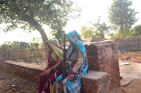 A woman carries a gun in a village in Madhya Pradesh