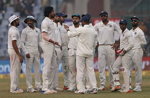 India's players gather as they celebrate dismissal of Sri Lanka's Sadeera Samarawickrama during the third day of their third Test match in New Delhi, India, Monday, Dec. 4, 2017. | AP