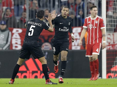 PSG's Kylian Mbappe, center, celebrates after scoring his side's opening goal during the Champions League Group B soccer match between FC Bayern Munich and Paris Saint-Germain, at Allianz Arena stadium in Munich. | AP