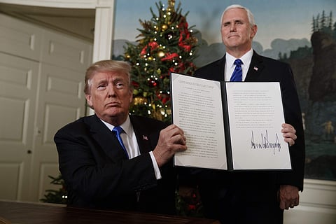 Vice President Mike Pence watches as President Donald Trump holds up a proclamation to officially recognize Jerusalem as the capital of Israel, in the Diplomatic Reception Room of the White House, Wednesday, Dec. 6, 2017, in Washington. (AP Photo)