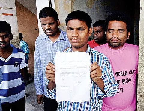 Visually challenged persons show mediapersons a letter describing the problems faced by them due to non-availability of power in the hostel | Express photo